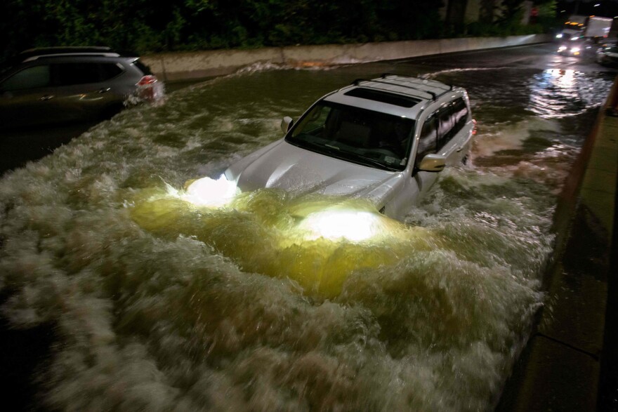 <strong>Thursday., Sept. 2: </strong>A motorist drives a car through a flooded expressway in Brooklyn, New York early on September 2, 2021, as flash flooding and record-breaking rainfall brought by the remnants of Storm Ida swept through the area.