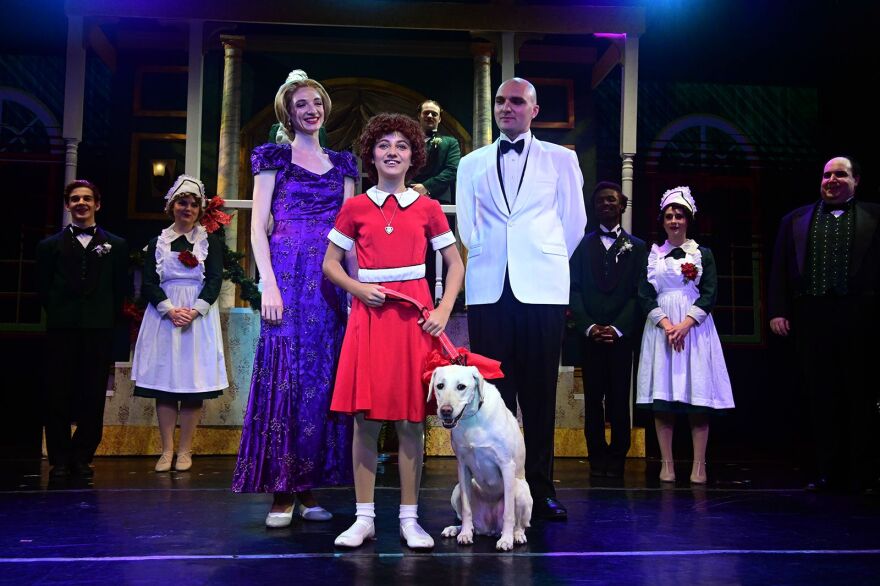 Teegan with Annie, Daddy Warbucks and his staff in the final scene of 'Annie'