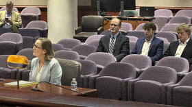 Sandra Slack Glover testifying Monday. Watching were her husband, Eric Glover, and their sons.