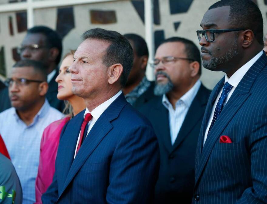 Suspended Broward County Sheriff Scott Israel, center, listens to comments by his attorney at a news conference after new Florida Gov. Ron DeSantis suspended Israel, Friday, Jan. 11, 2019, in Fort Lauderdale, Fla., over his handling of the massacre.