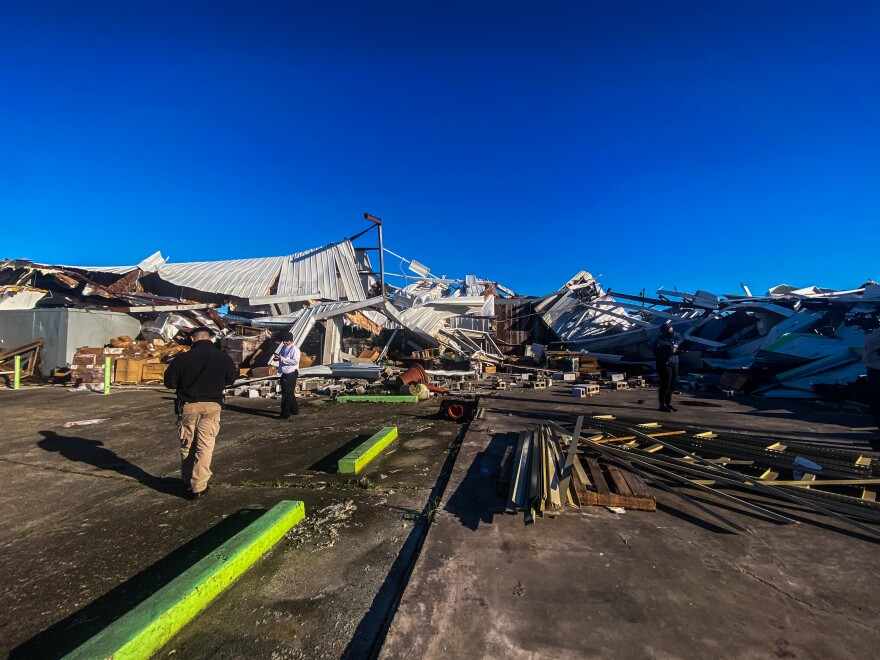 Folks survey damage in Arabi.