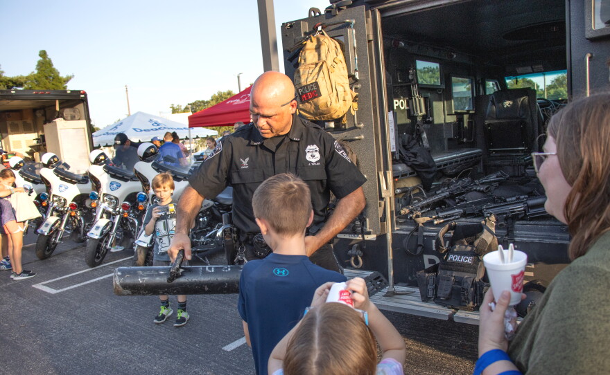 EPD Swat Team Officer Jeff Taylor shows National Night Out attendees a battering ram built by the SWAT team.