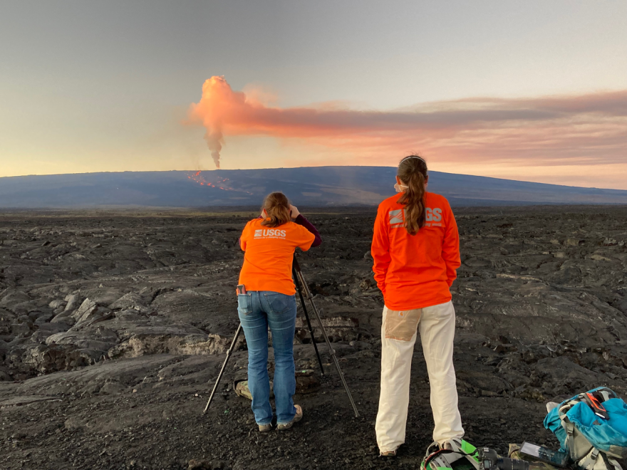 Taken from the intersection of the Daniel K. Inouye Highway and the old saddle road, USGS scientists take laser rangefinder measurements of the main flow front of fissure 3 from Mauna Loa’s Northeast Rift Zone eruption to determine where it is relative to the highway.