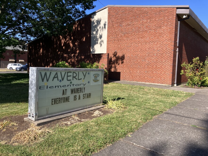 A school. The sign in front reads: "Waverly Elementary. At Waverly, everyone is a star!"