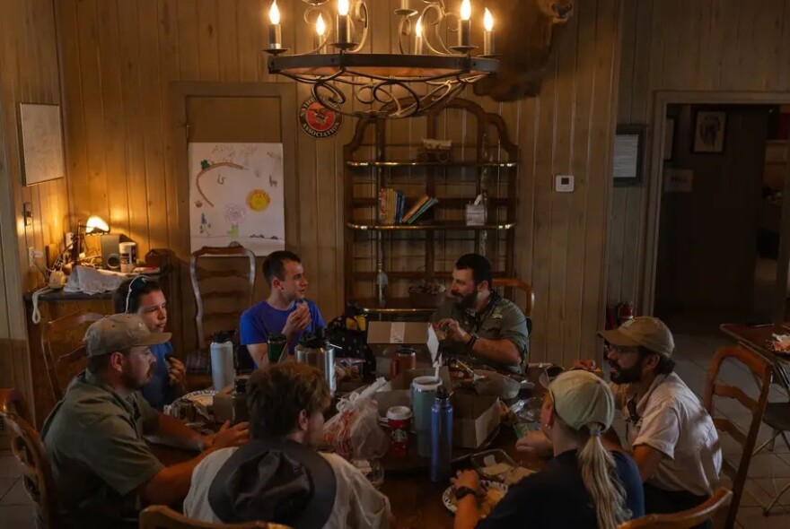Texas Parks and Wildlife Department biologists, staff, and interns sit down for lunch following an aquatic sampling for amphibians and fish at Yancey Creek.