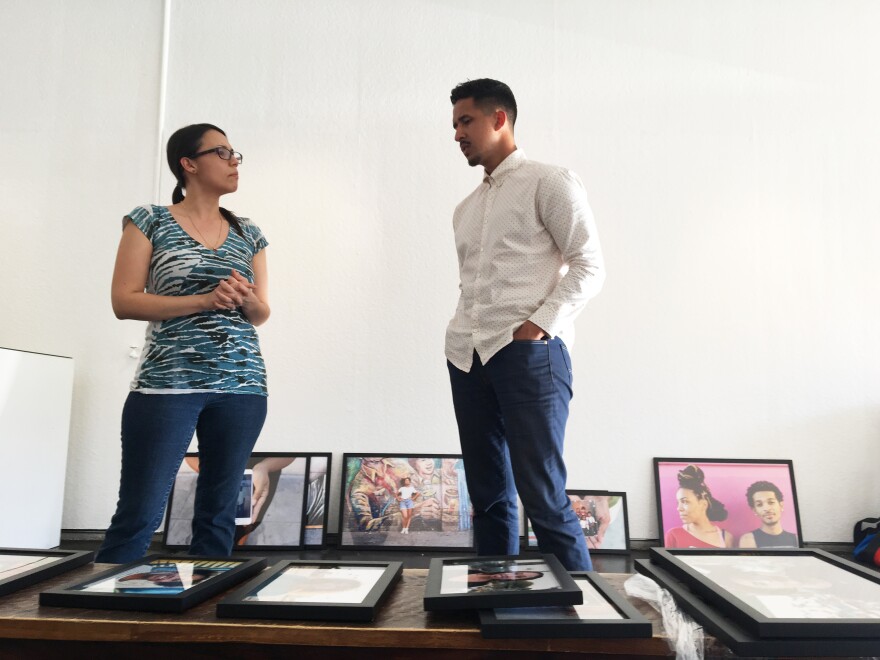 Curator Nathalie Sanchez and Walter Thompson-Hernandez set up an exhibit of his photos at a gallery in Los Angeles.