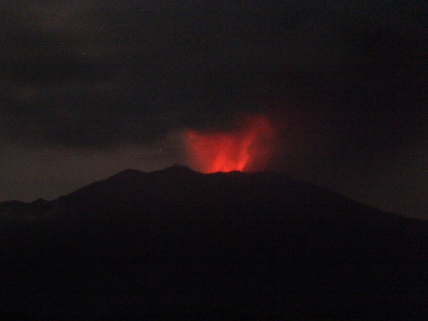 Mount Raung spews volcanic materials as seen from Sumber Arum village in Banyuwangi, East Java, Indonesia, on Friday.