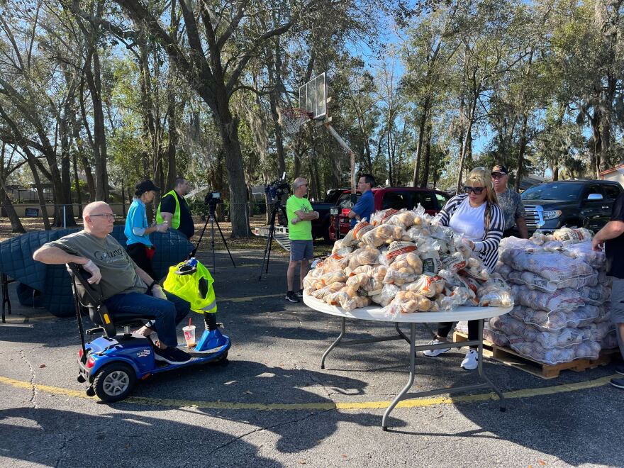 Volunteers set up food packs to distribute.