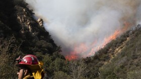 A firefighter monitors a wildfires burning along a hillside Sunday, Nov. 11, 2018, in Malibu, Calif. Fire officials say the lull allowed firefighters to gain 10 percent control of the so-called Woolsey fire, which has burned more than 130 square miles in western Los Angeles County and southeastern Ventura County since Thursday. (Jae C. Hong/AP)