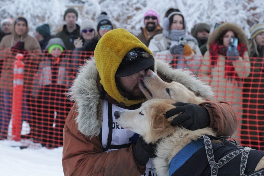 Quest 550 musher Brent Sass shares a moment with his lead dogs before the start.