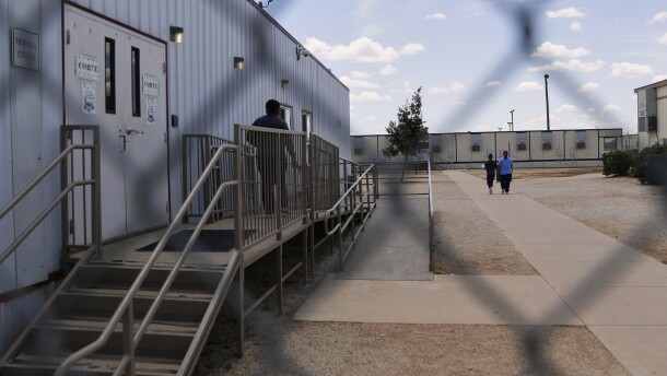 File - Immigrants seeking asylum walk through the ICE South Texas Family Residential Center in Dilley, Texas.