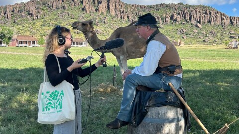 PHOTO OF THE WEEK: Marfa Public Radio’s Zoe Kurland with Texas Camel Corps’ Doug Baum at the Fort Davis National Historic Site. Photo by Dave Harding.
