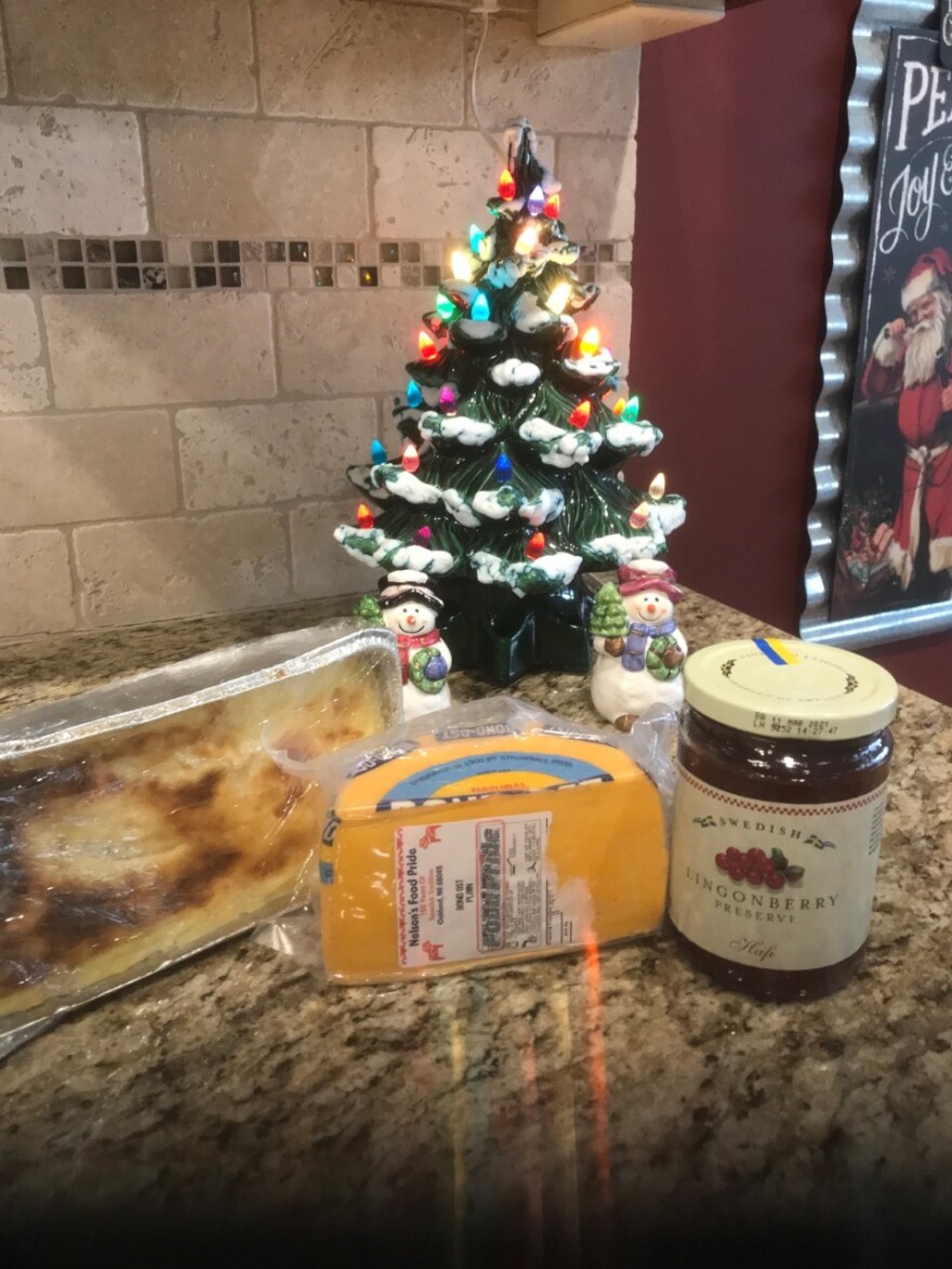 Aluminum pan of ostkaka, bond ost (Swedish cheese that tastes like rich cheddar), and traditional lingonberry jelly.