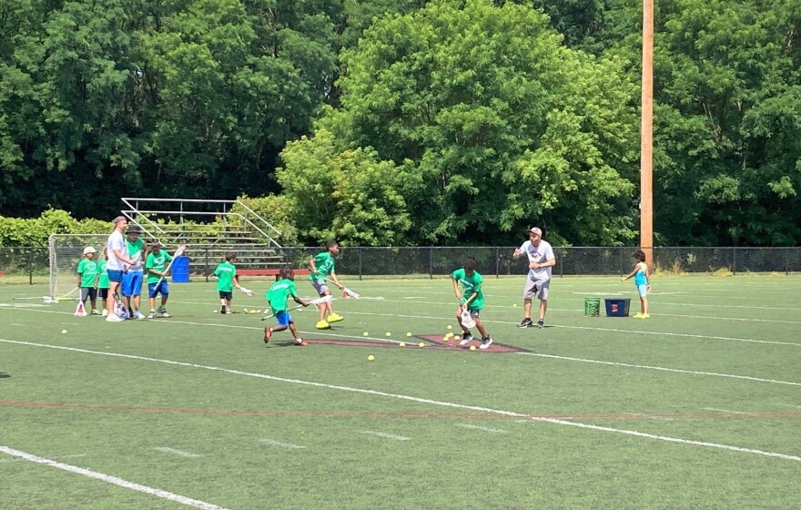 Participants at the Syracuse Police Athletic League camp play lacrosse at Meachem Field behind Clary Middle School, July 8, 2022. 