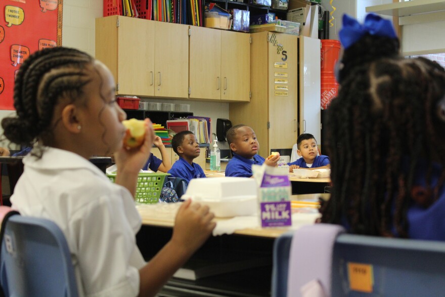 Children eat breakfast on the first day of school in New Orleans on Aug. 4, 2025.