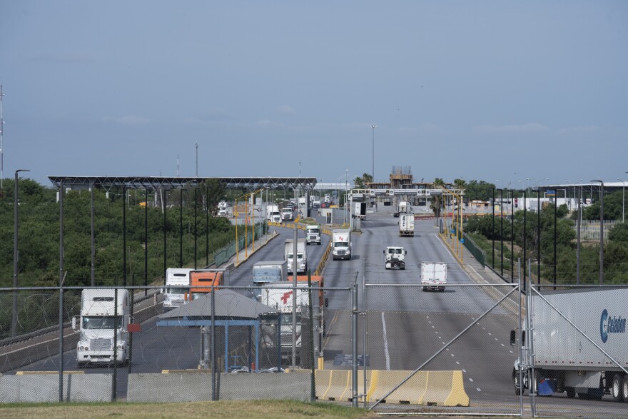 File Photo: To the left, trucks coming from Mexico enter the U.S. through the World Trade Bridge in Laredo, Texas.