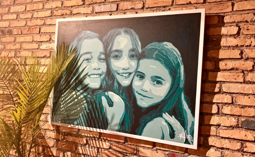 The walls upstairs at Off The Clock, from the stairs to the entrance, are sprawled with work by the restaurant’s resident artist, Haiti-born Rousell Dad.