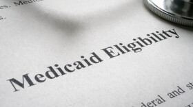 Info about Medicaid eligibility and stethoscope on a paper