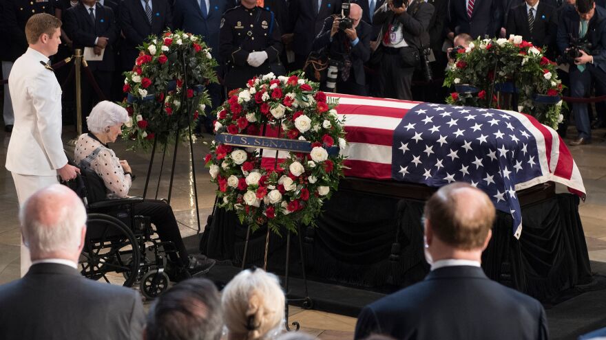 Roberta McCain, mother of John McCain, pays respects before his flag-draped casket Friday at the Capitol rotunda. His final public memorial was Saturday at the National Cathedral.