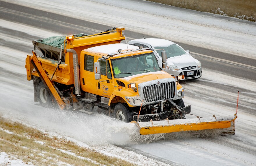 Missouri Department of Transportation snow plows drive east while treating ice and snow building up on Interstate 44 on Wednesday, Feb. 2, 2022 in St. Louis, Mo.