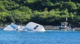 Pictured: Pictured: The recreational vessel Aquarius assists the captain of the 42-foot catamaran, Cool Change, near Christmas Cove off St. Thomas.