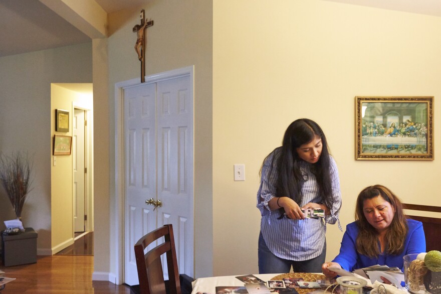 Alondra (left) and her mother, Araceli, look through family photographs after a Sunday Mass and family lunch. Araceli has three jobs to provide for her family.