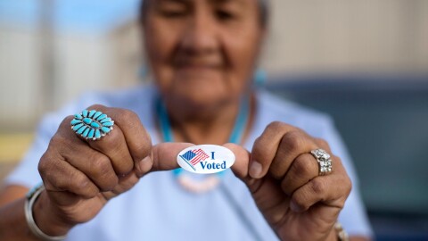 A woman shows off her ‘I voted’ sticker in Window Rock, Arizona, in August 2018.