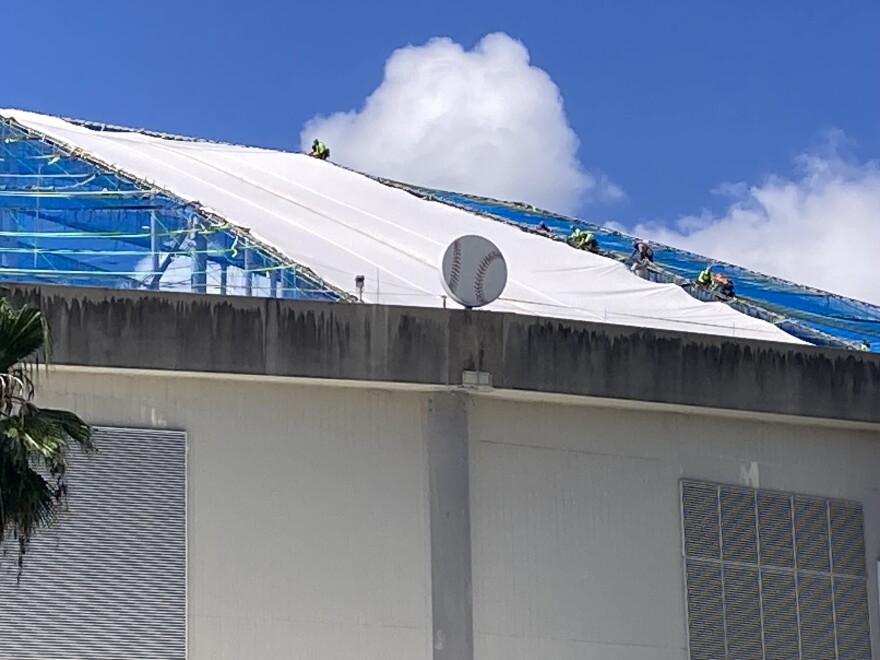 workers on top of the dome roof