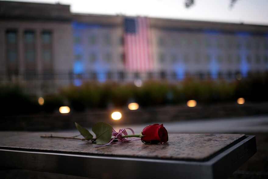 A rose lays on a bench at the National 9/11 Pentagon Memorial on Sept. 11, 2021, in Arlington, Va.