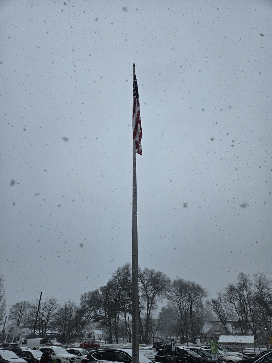 An American flag hangs over the parking lot of the Great Barrington, Massachusetts, Stop & Shop in the falling snow on March 3, 2026.
