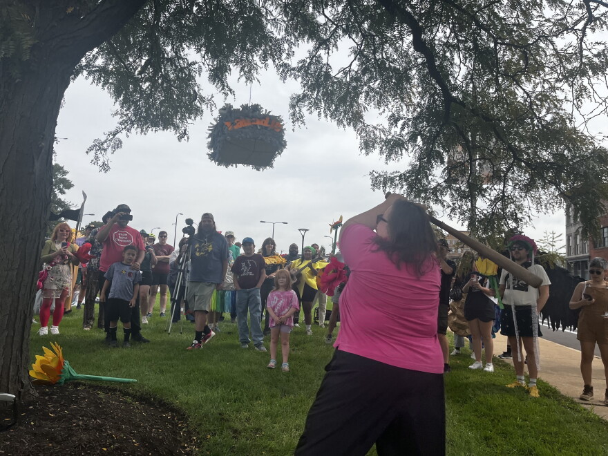 Patricia Schuba, president of the Labadie Environmental Organization, swings a bat at a piñata representing the Labadie Coal Plant on Saturday outside Ameren Missouri's St. Louis headquarters. Schuba lives near the coal plant and said it makes her and her neighbors sick.