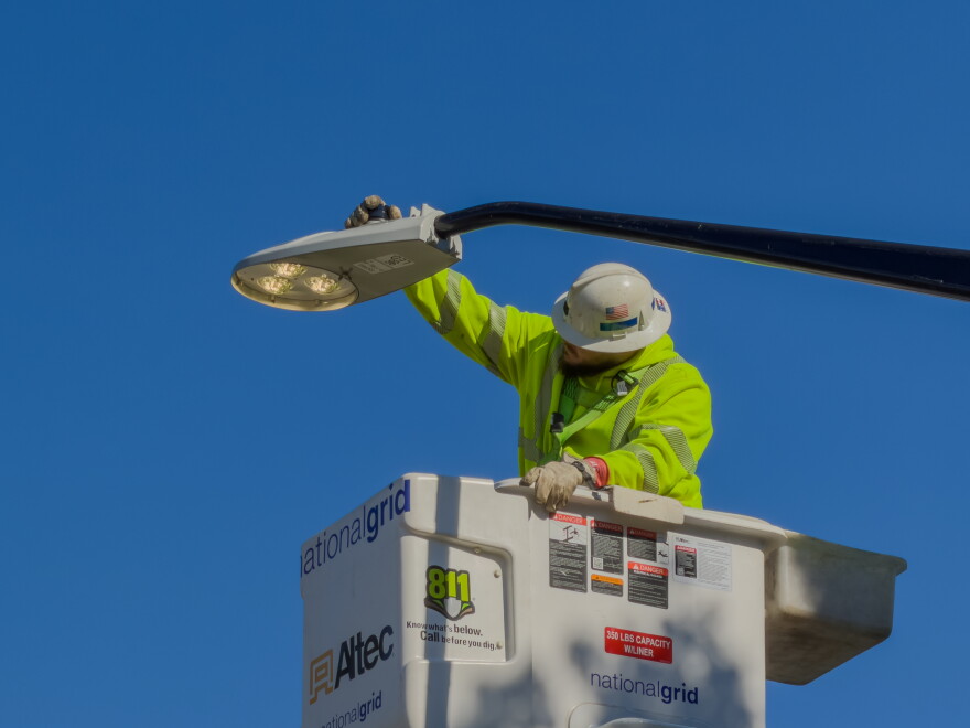 A National Grid employee turns on a street light that has just been replaced on Memorial Drive as part of Buffalo's City of Light initiative.