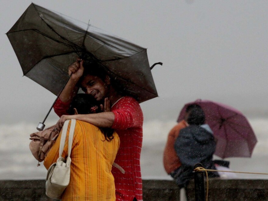 A couple walks in the rain in Mumbai in 2007.