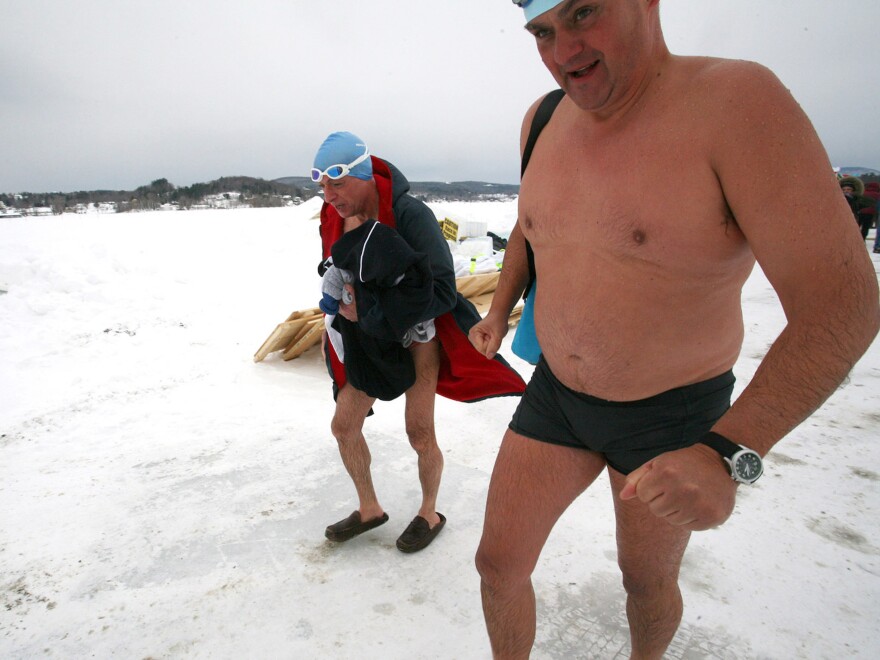 Silverio Bracaglia (left) and John Coningham-Rolls of London walk back to the warming hut after competing in the first U.S. Winter Swimming Championships at Lake Memphremagog in Newport, Vt.