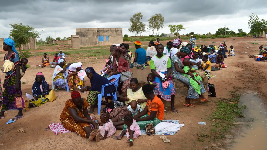 Women wait by a maternal health care clinic in Pabre, Burkina Faso, for a free cervical cancer screening.