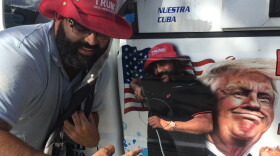 Conservative Cuban-American voter Alberto Hernandez shows off the picture of President Trump on his painting company's pickup truck in Kendall on Tuesday.