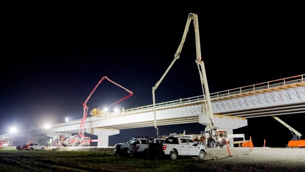 Crews work at night on the ramps to the new I-69 bridge that will connect Evansville, IN and Henderson, KY