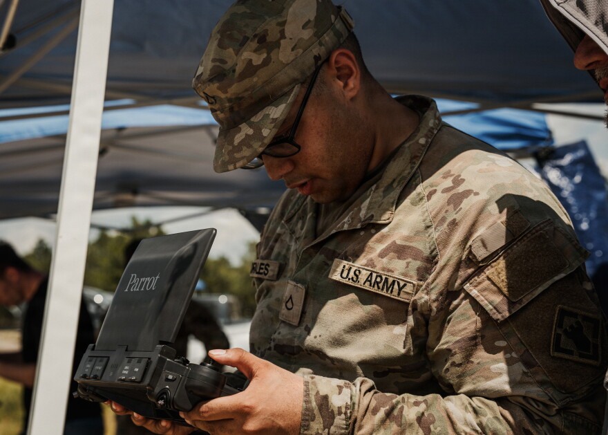 A soldier operates a controller during drone testing at Fort Bragg, N.C. Aug. 19, 2026. During the exercise, the Army tested a variety of AI-controlled equipment, including self-driving vehicles, drones, and self-firing weapons.