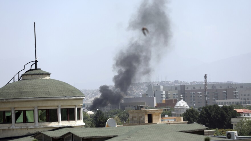 Smoke rises next to the U.S. Embassy in Kabul, on Sunday. Taliban fighters have entered the outskirts of the Afghan capital, further tightening their grip on the country. [Rahmat Gul / AP]