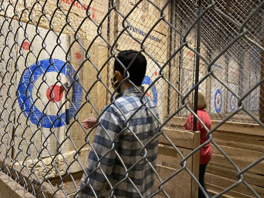 Tall chain-link fences separate the lanes or pits for safety.