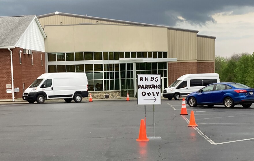 White vans shuttled people from Rolling Hills Baptist Church a half mile to Applebee's Tuesday evening.