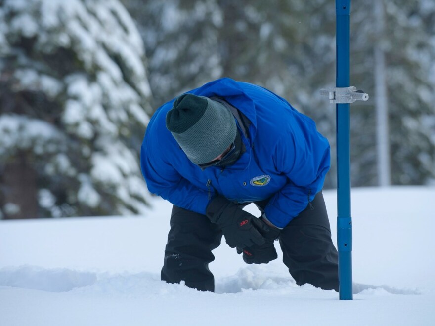 Sean de Guzman, chief of snow surveys for the California Department of Water Resources, checks the depth of the snow pack during the first snow survey of the season at Phillips Station near Echo Summit, Calif., Thursday, Dec. 30, 2021.