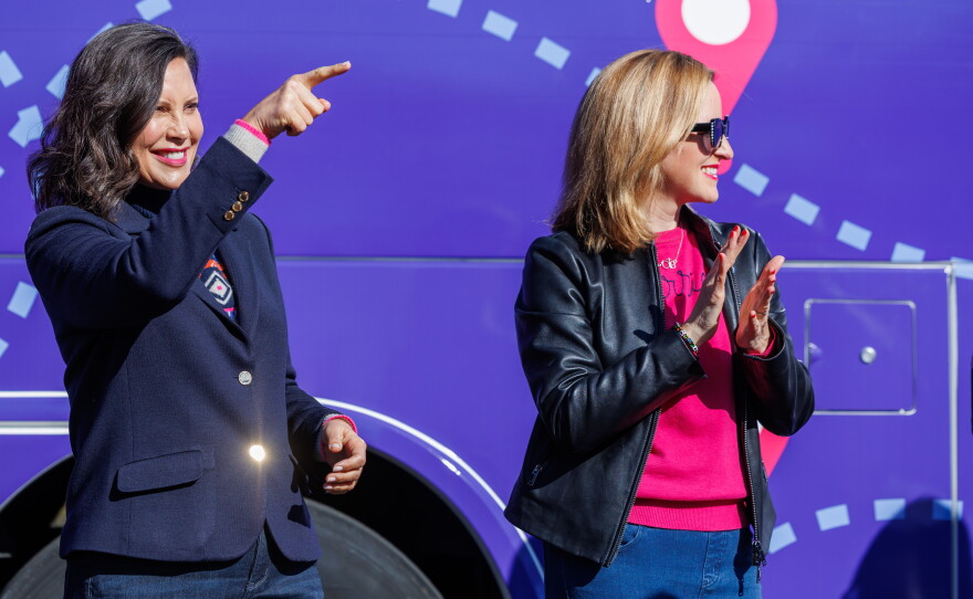 Gov. Gretchen Whitmer, left, and Democratic gubernatorial nominee Jocelyn Benson, right, during the first stop on Benson's statewide "Driving Down Costs" bus tour in East Lansing, Mich., on Oct. 22, 2026.