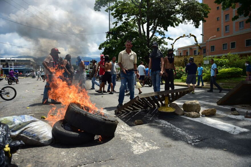 Anti-government activists set up a barricade in the streets of Venezuela's third city, Valencia, on Aug. 6, 2017, a day after a new assembly with supreme powers and loyal to President Nicolas Maduro started functioning in the country. In a video posted online earlier, allegedly at an army base used by the National Bolivarian Armed Forces in Valencia, a man presenting himself as an army captain declared a "legitimate rebellion ... to reject the murderous tyranny of Nicolas Maduro" and demanded a transitional government and "free elections." After the video surfaced, military chiefs said troops had put down the "terrorist" attack. (Ronaldo Schemidt/AFP/Getty Images)
