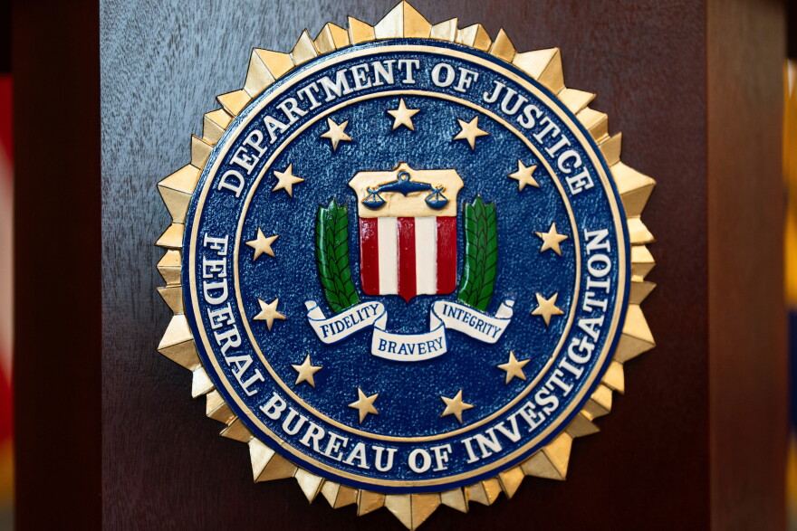 FILE - An FBI seal is displayed on a podium before a news conference at the field office in Portland, Ore., Jan. 16, 2025.