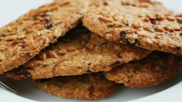 Brown round cookies served on a white ceramic plate.