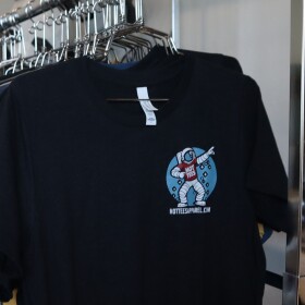 A rack of shirts with the Hot Tees logo hangs in the company's office on March 18, 2025