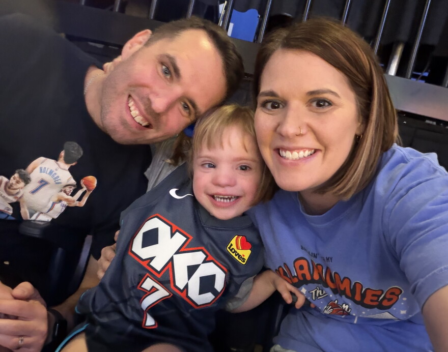Ross and Elizabeth Duren pose with their five-year-old daughter, Gentry, at an Oklahoma City Thunder game. They attended the game through a grant from the Sam the I Can Man Foundation.