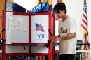 Thomas Kuhn fills out his ballot during early voting, Tuesday, Oct. 28, 2025, in Portland, Maine.