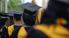 Caps and gowns of a row of former students of Jefferson County Public Schools are seen during a makeup graduation ceremony at Central High School in Louisville, Kentucky.